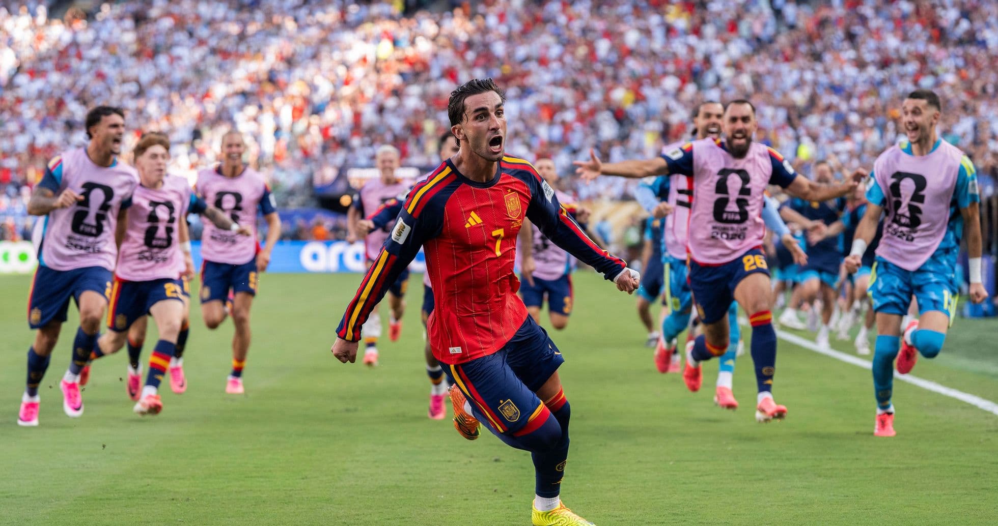 Spanish player celebrating a goal with teammates Spanish player celebrating a goal with teammates
