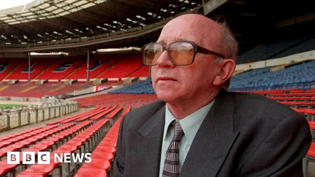 Man seated in empty stadium stands at Wembley Man seated in empty stadium stands at Wembley