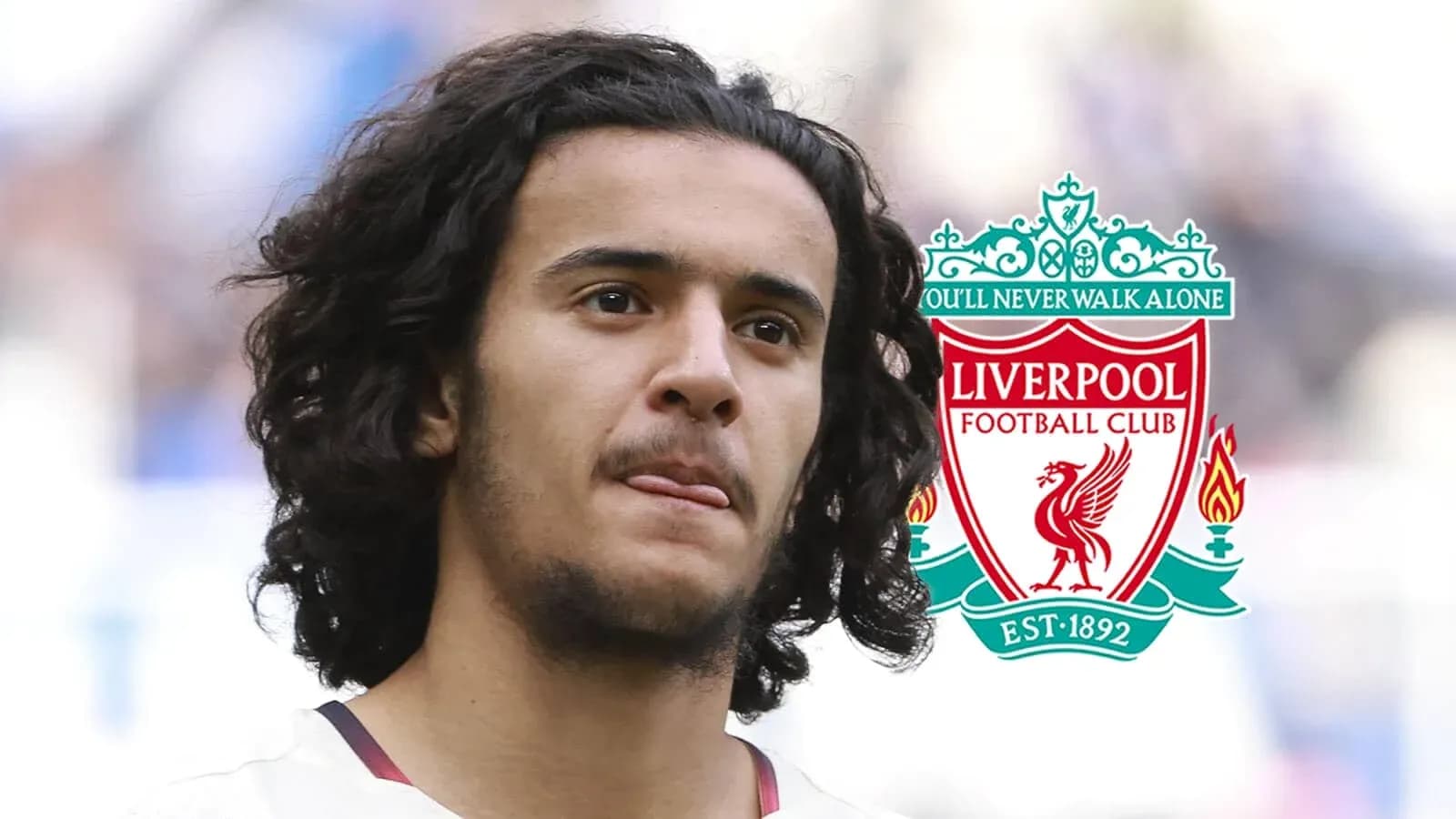 Player with curly hair and Liverpool FC logo Player with curly hair and Liverpool FC logo