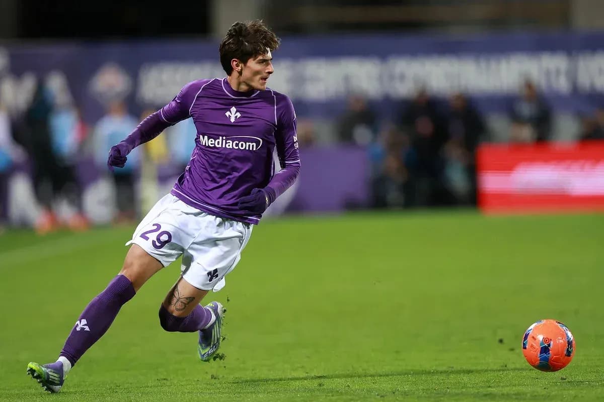 Player in purple jersey running after soccer ball Player in purple jersey running after soccer ball