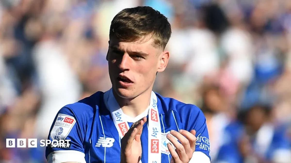 Player wearing blue jersey applauding fans Player wearing blue jersey applauding fans