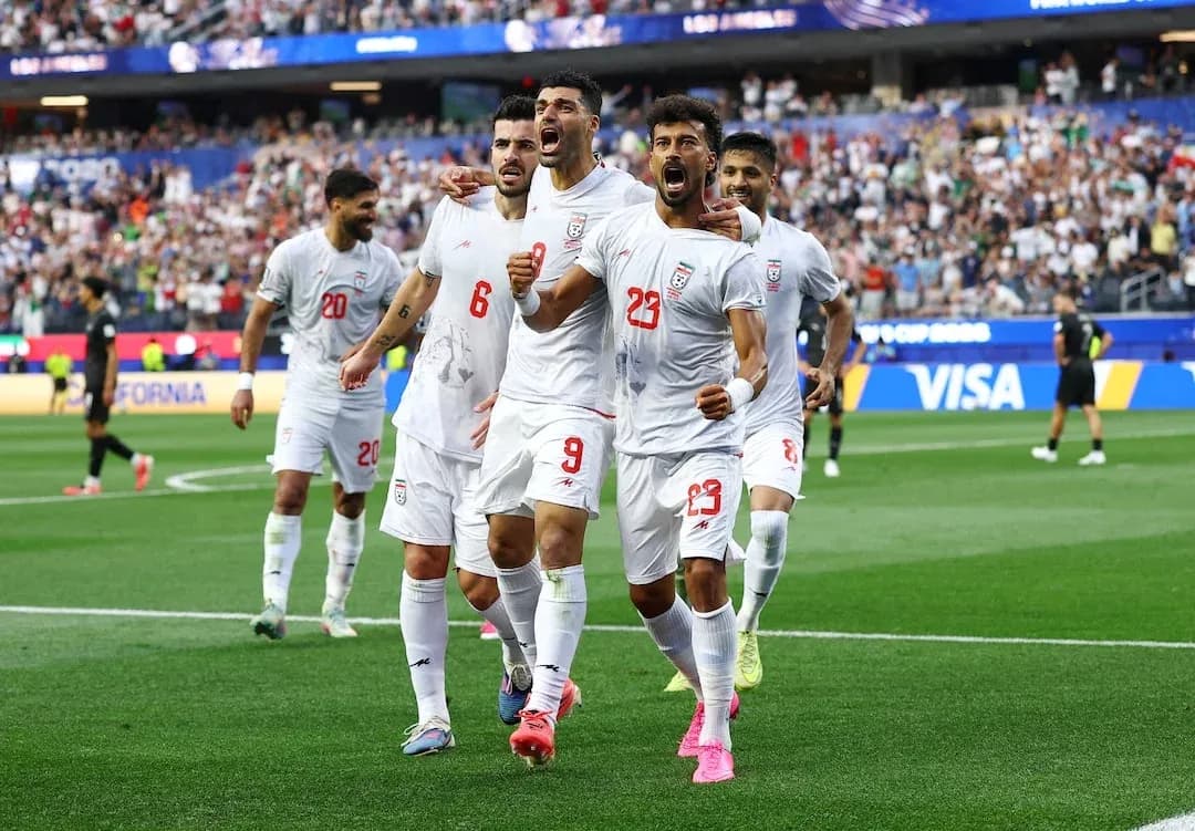 Iran players celebrating during a football match Iran players celebrating during a football match