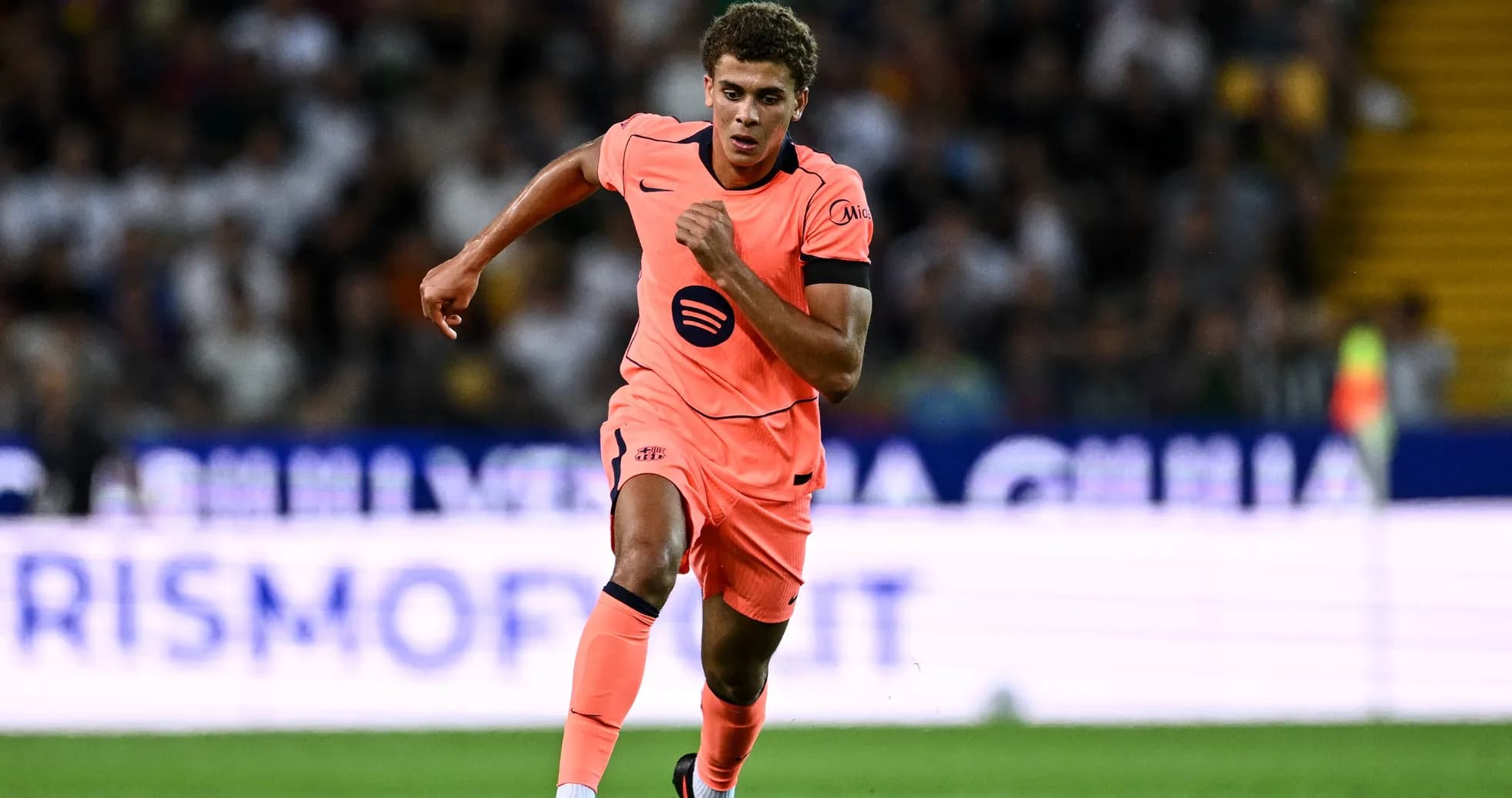 Player in pink kit running during match Player in pink kit running during match