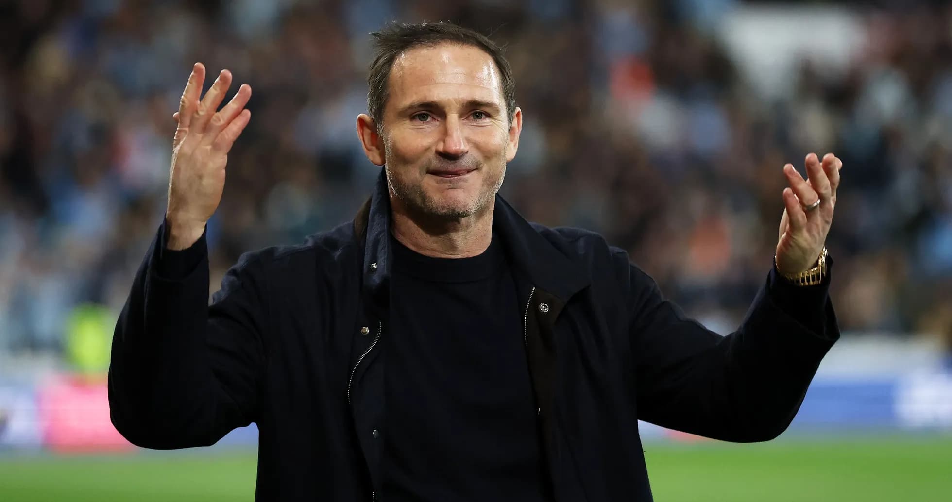Manager gesturing to fans during a match Manager gesturing to fans during a match