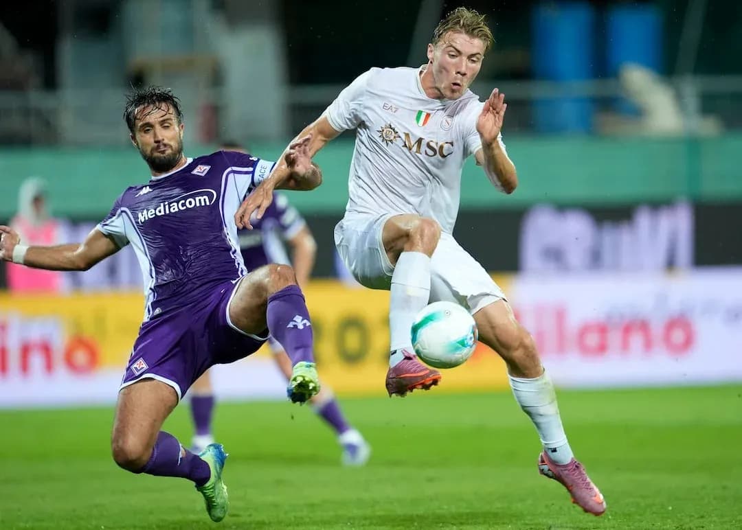 Fiorentina player tackling Napoli opponent Fiorentina player tackling Napoli opponent