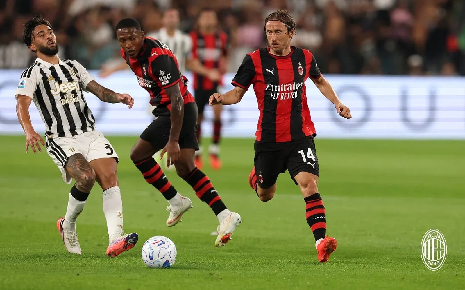 Juventus player challenged by AC Milan opponents Juventus player challenged by AC Milan opponents