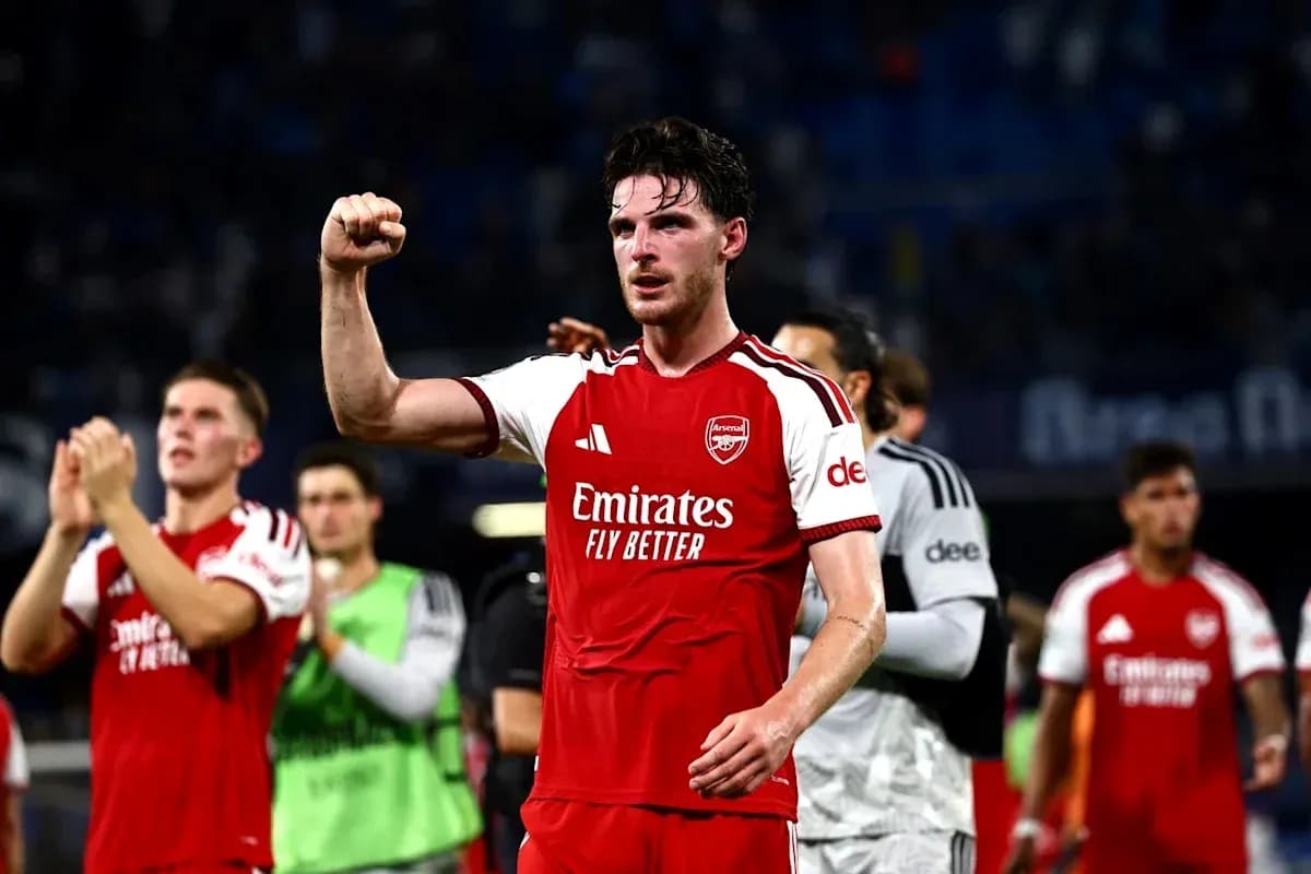 Player celebrating after match with teammates in background Player celebrating after match with teammates in background