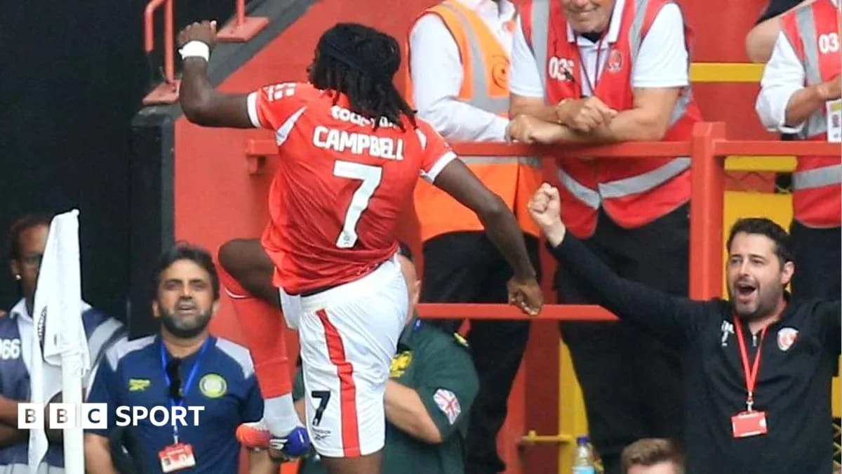Player celebrating a goal with fans in stadium Player celebrating a goal with fans in stadium