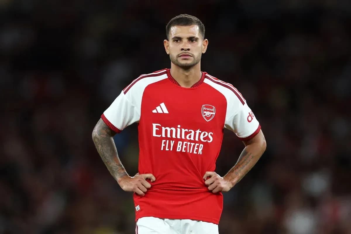 Player in Arsenal kit standing on the field Player in Arsenal kit standing on the field