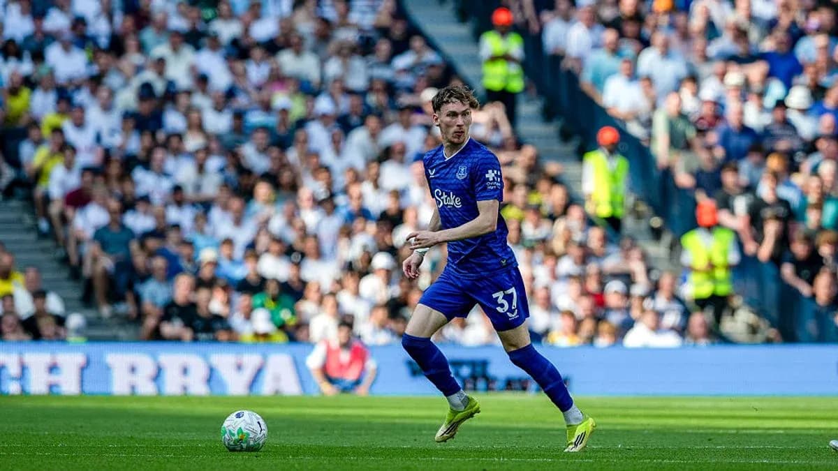 Player in blue kit running with the ball Player in blue kit running with the ball