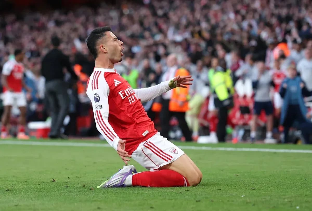 Player celebrating after scoring a goal for Arsenal Player celebrating after scoring a goal for Arsenal