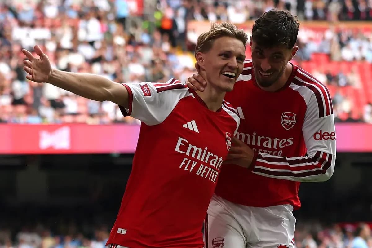 Arsenal players celebrating a goal together Arsenal players celebrating a goal together