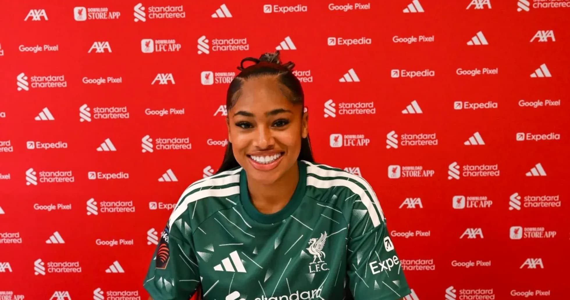 Player in Liverpool kit at press conference backdrop Player in Liverpool kit at press conference backdrop