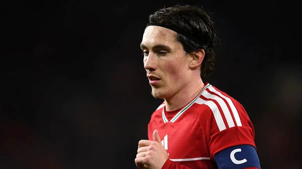 Player in red jersey with captain's armband during match Player in red jersey with captain's armband during match