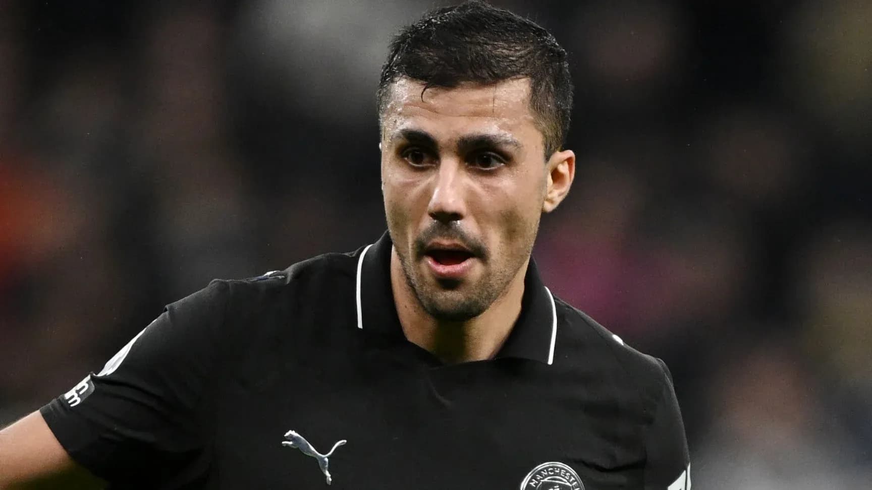 Player in black kit during match action Player in black kit during match action