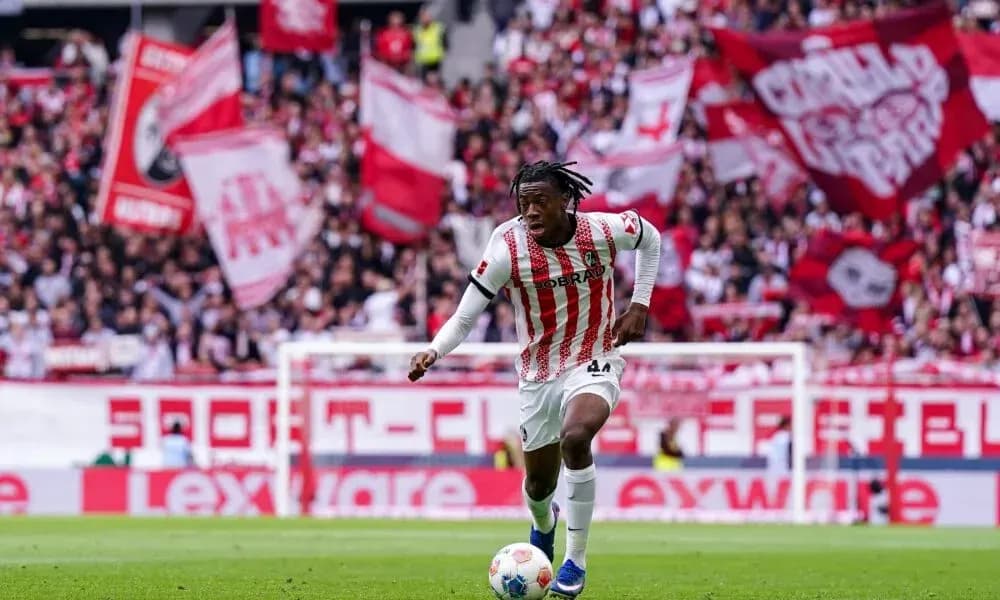 Player sprinting with ball amid cheering crowd Player sprinting with ball amid cheering crowd