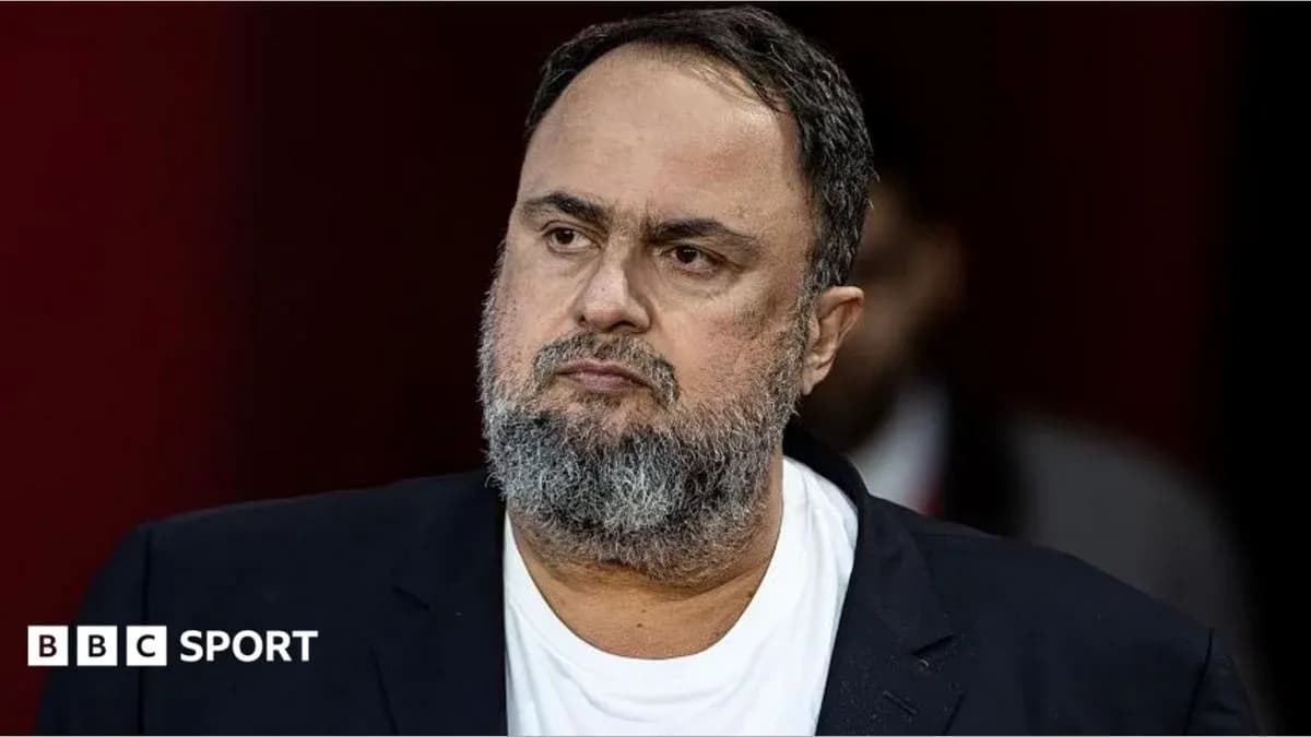 Man with beard in black blazer, serious expression Man with beard in black blazer, serious expression