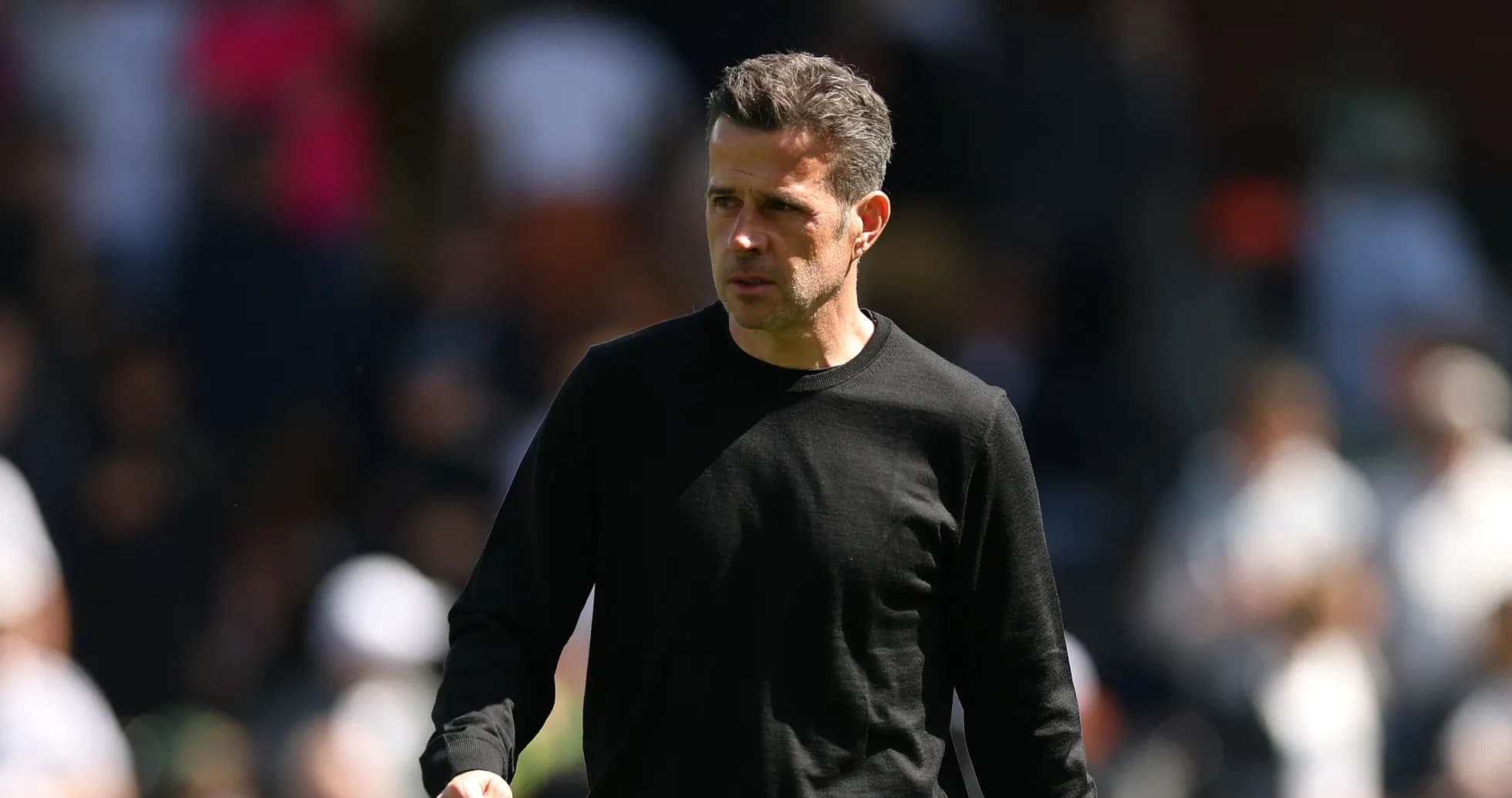 Coach walking on the pitch during match Coach walking on the pitch during match