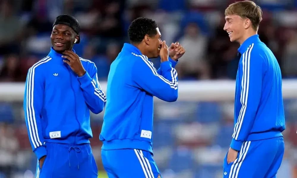 Three players in blue training outfits laughing together Three players in blue training outfits laughing together