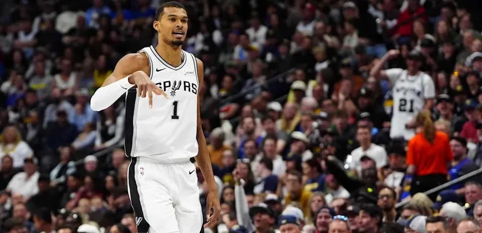 Player gesturing during game with fans in background Player gesturing during game with fans in background