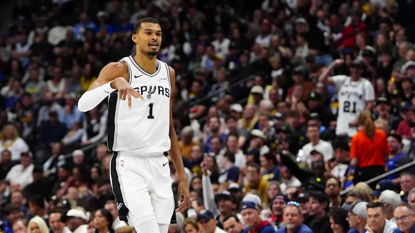 Player gesturing during game with fans in background Player gesturing during game with fans in background