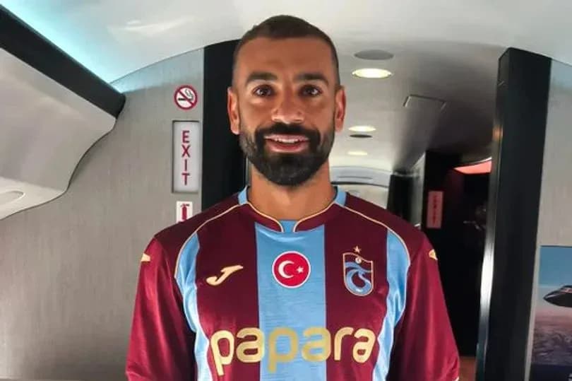 Player wearing Trabzonspor jersey in airplane corridor Player wearing Trabzonspor jersey in airplane corridor