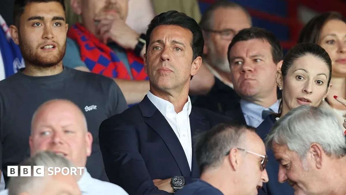 Fans watching a match in the stadium stands Fans watching a match in the stadium stands