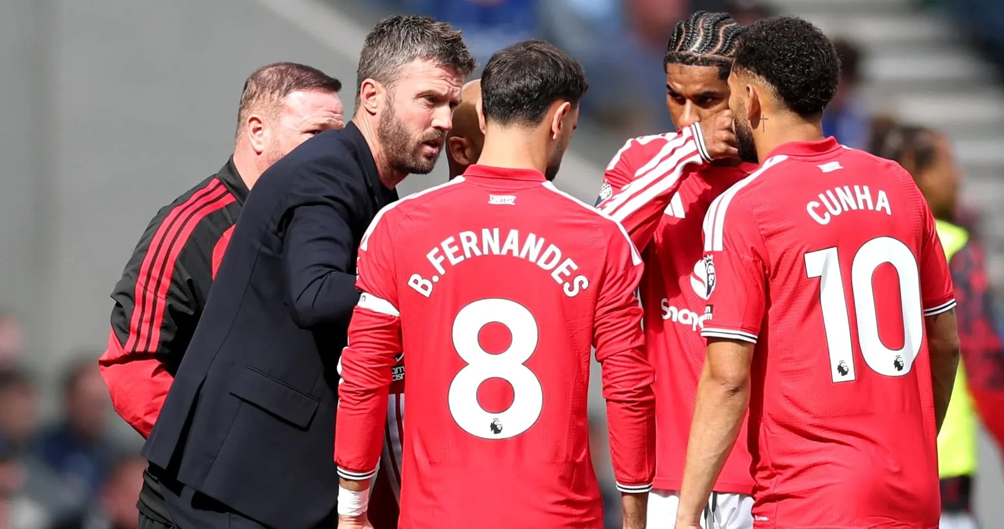 Manager discussing strategy with Manchester United players Manager discussing strategy with Manchester United players