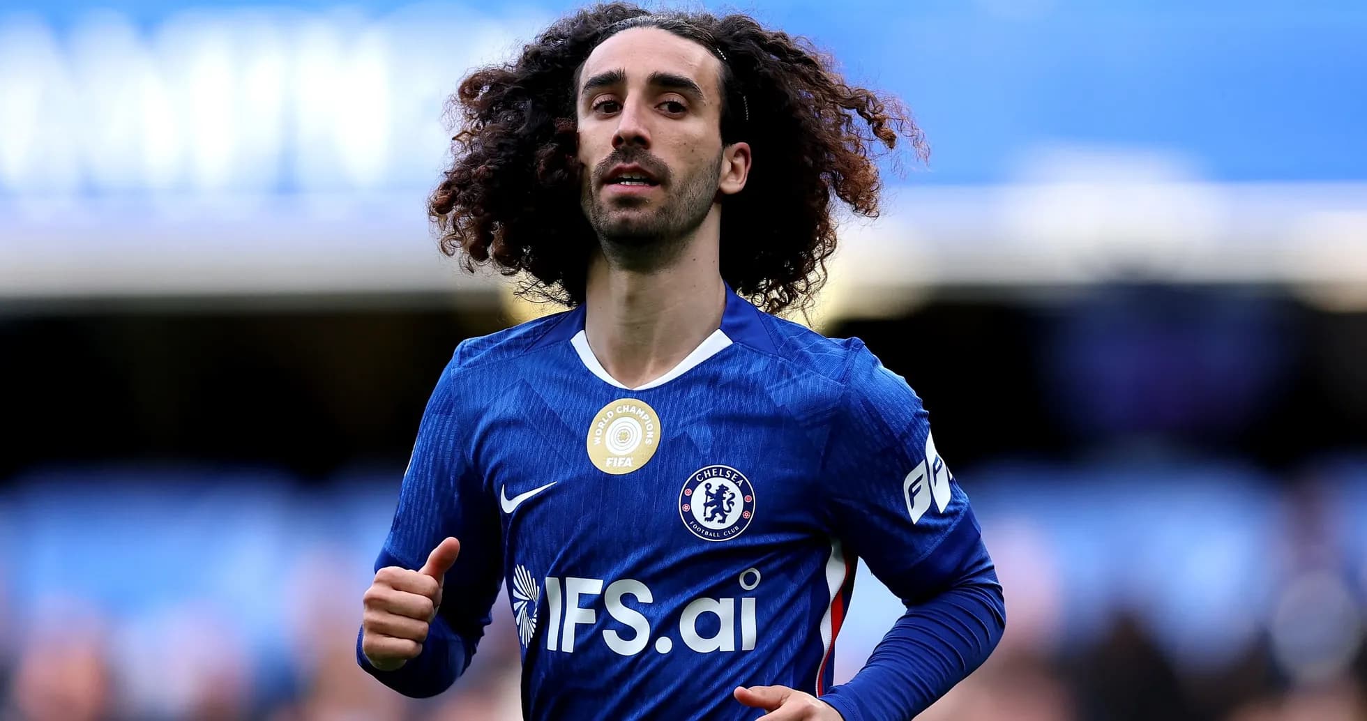 Player in Chelsea jersey running on the pitch Player in Chelsea jersey running on the pitch