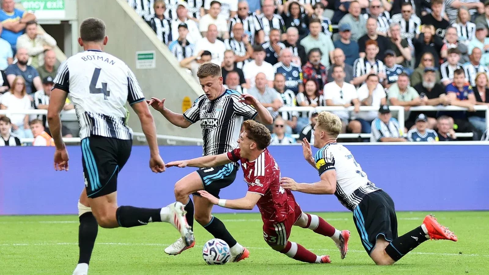 Players contesting the ball during a football match Players contesting the ball during a football match