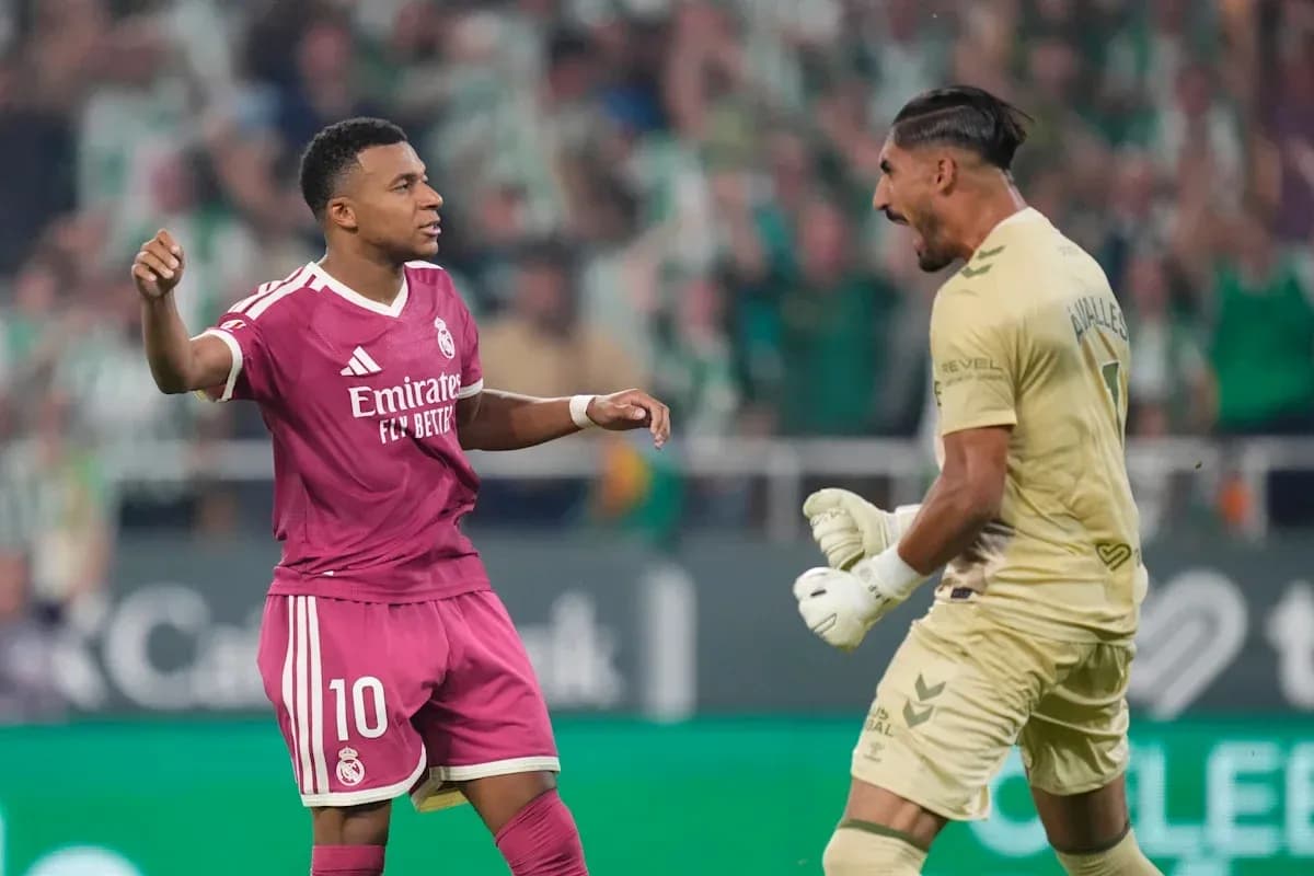 Player celebrating after scoring against the goalkeeper Player celebrating after scoring against the goalkeeper