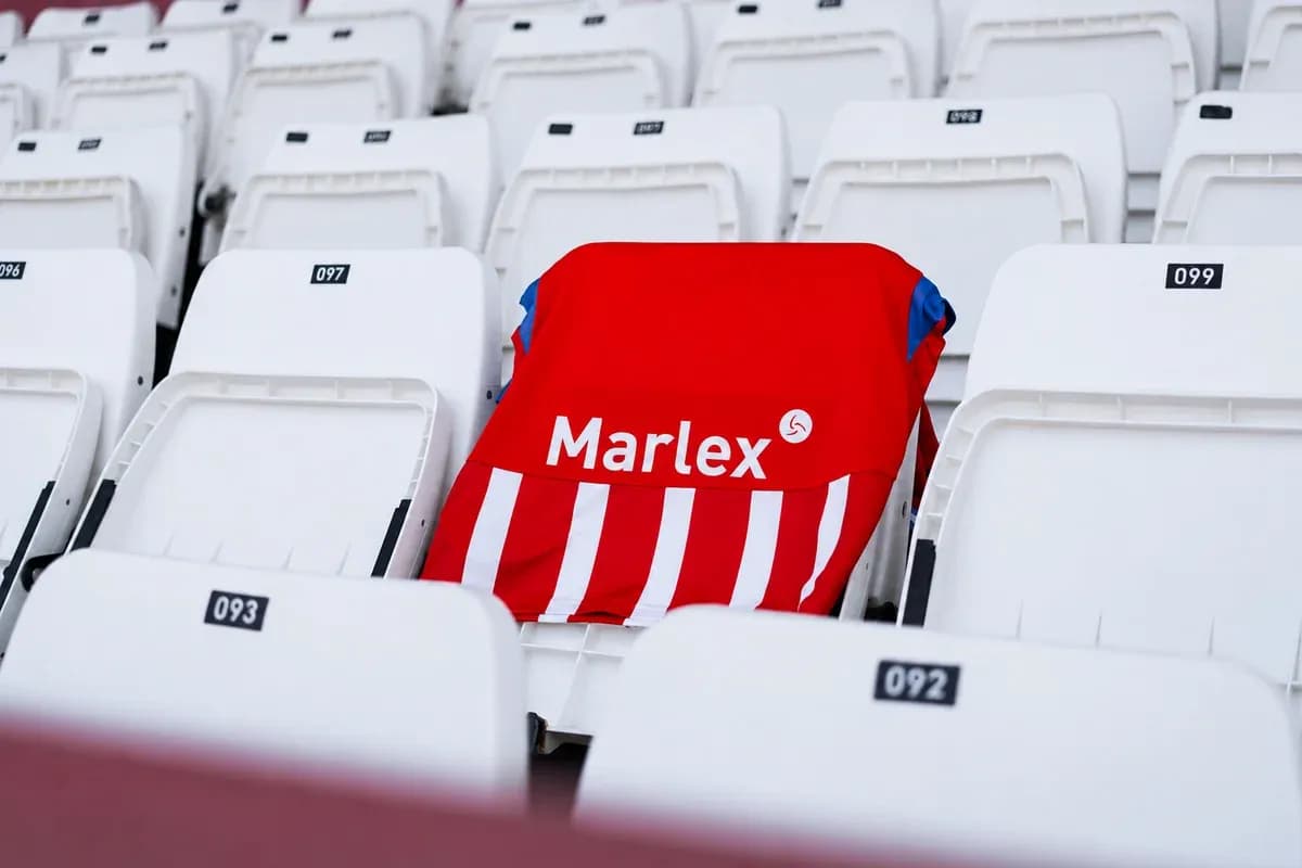 Red and white jersey placed on empty stadium seat Red and white jersey placed on empty stadium seat