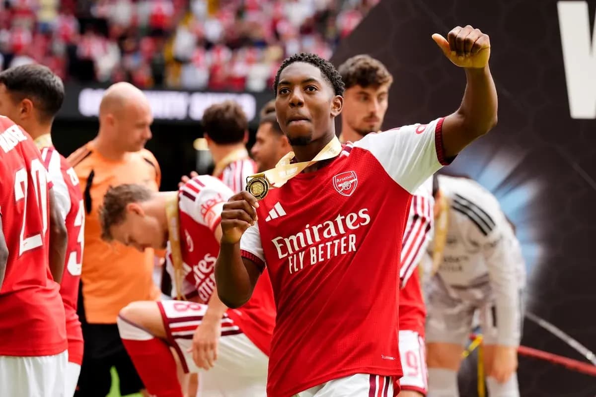 Player celebrating with medal after match victory Player celebrating with medal after match victory