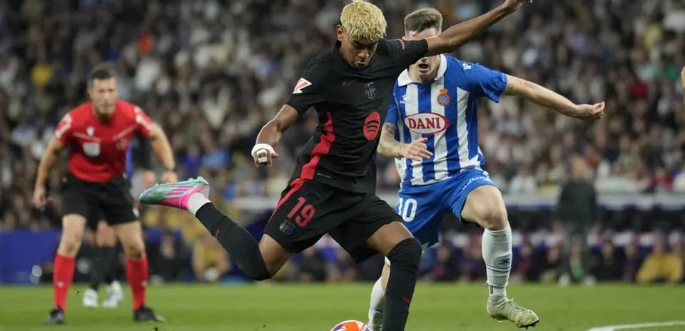 Barcelona player kicking ball against Espanyol Barcelona player kicking ball against Espanyol