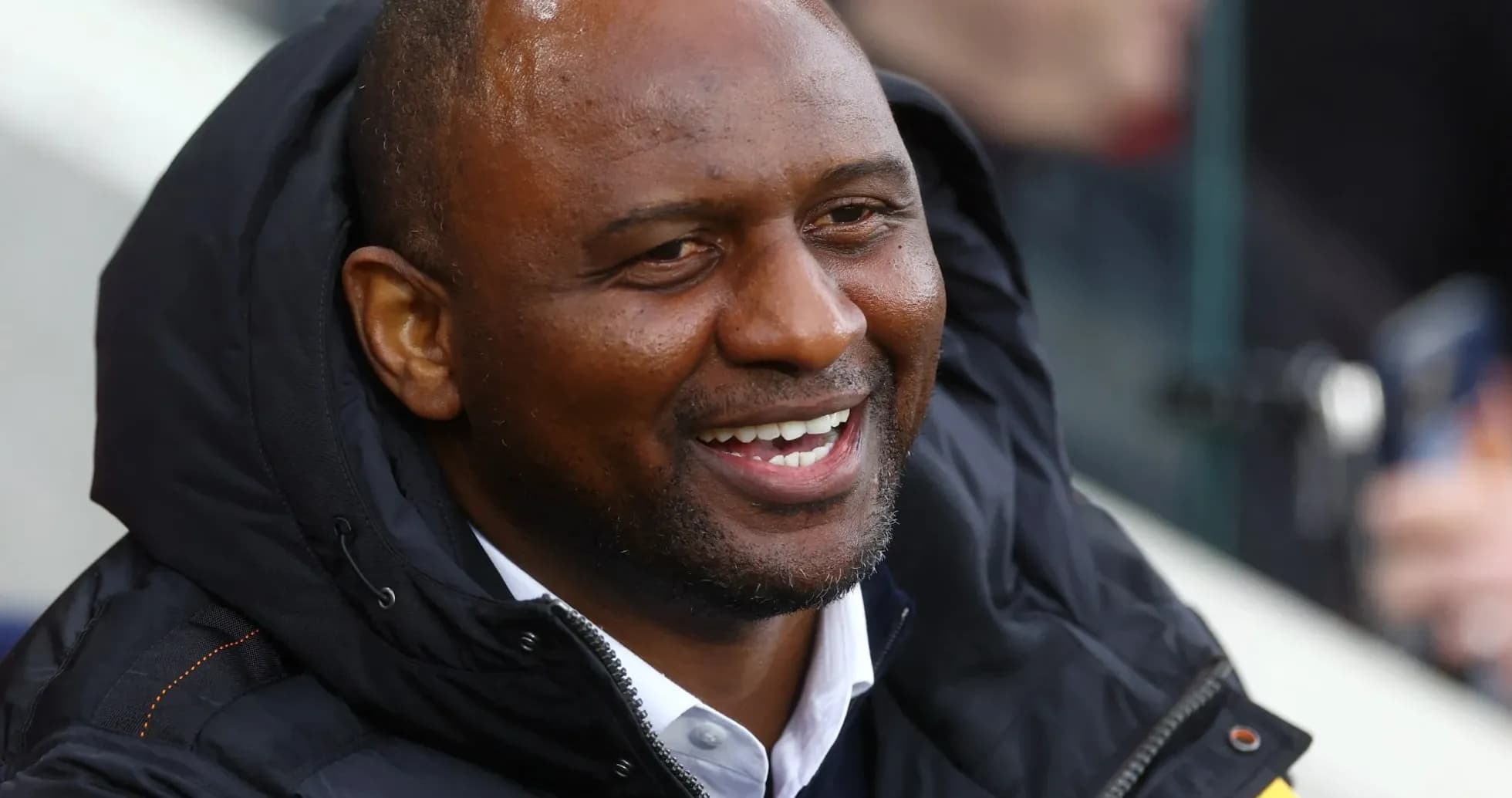 Man smiling while seated in the stands Man smiling while seated in the stands