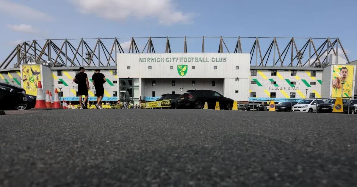 Two people walking towards Norwich City Football Club Two people walking towards Norwich City Football Club