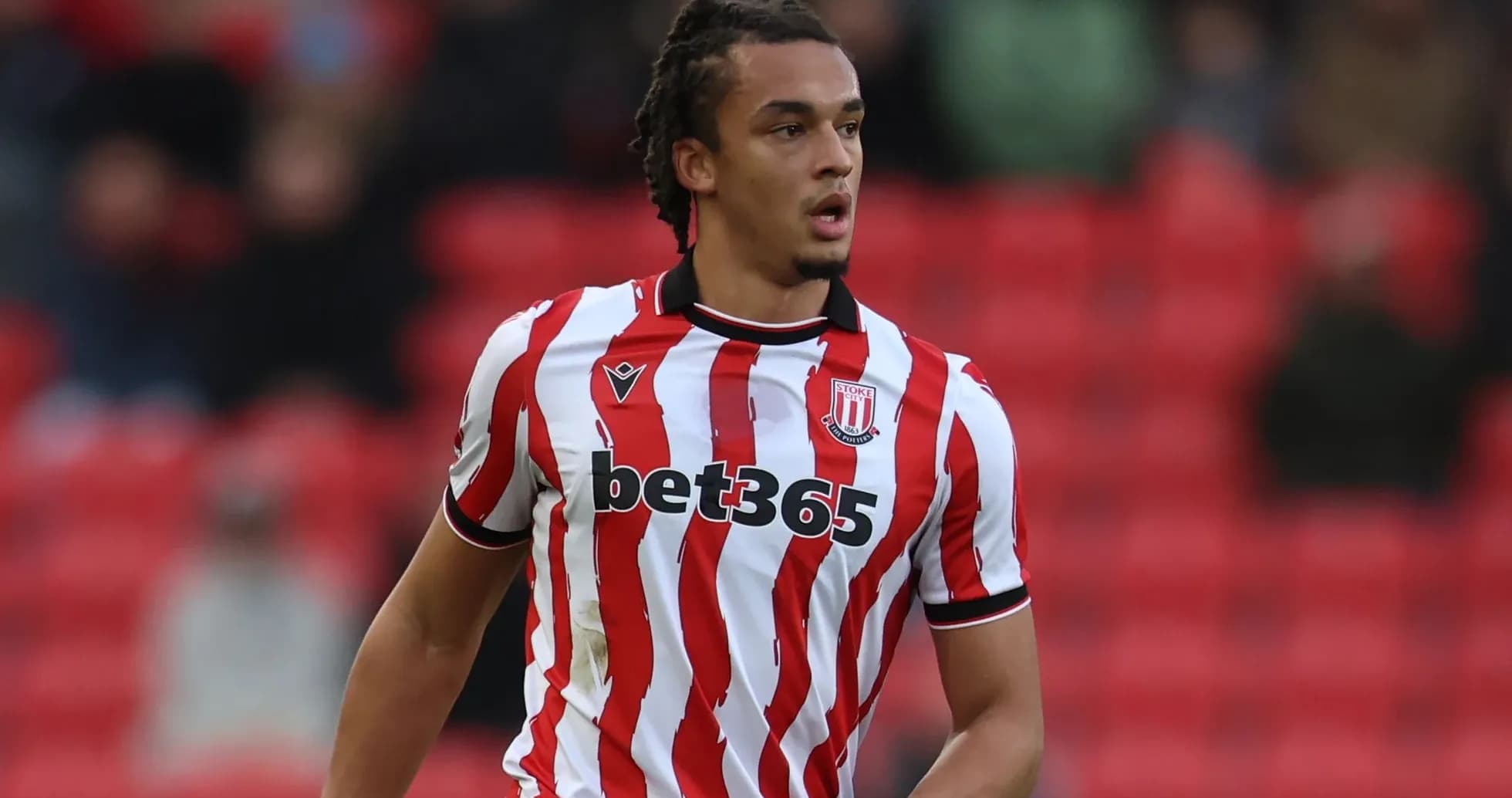 Player in Stoke City jersey on the pitch Player in Stoke City jersey on the pitch