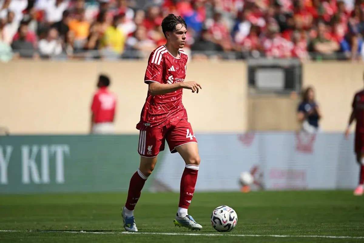 Liverpool player dribbling the ball on field Liverpool player dribbling the ball on field