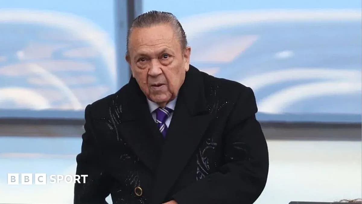 Man in a coat at a sports event Man in a coat at a sports event