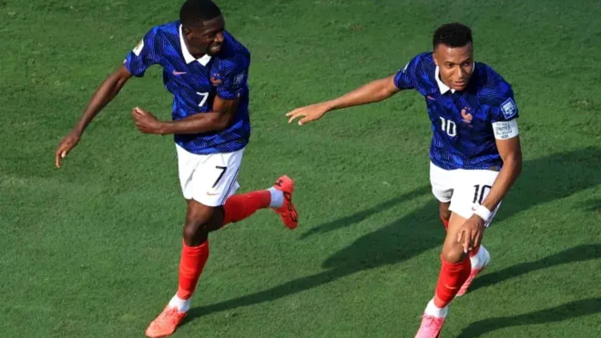 Two players celebrating a goal on the field Two players celebrating a goal on the field