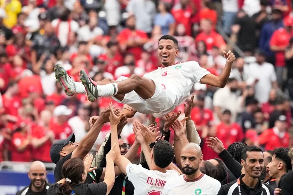 Player being lifted by teammates in celebration Player being lifted by teammates in celebration