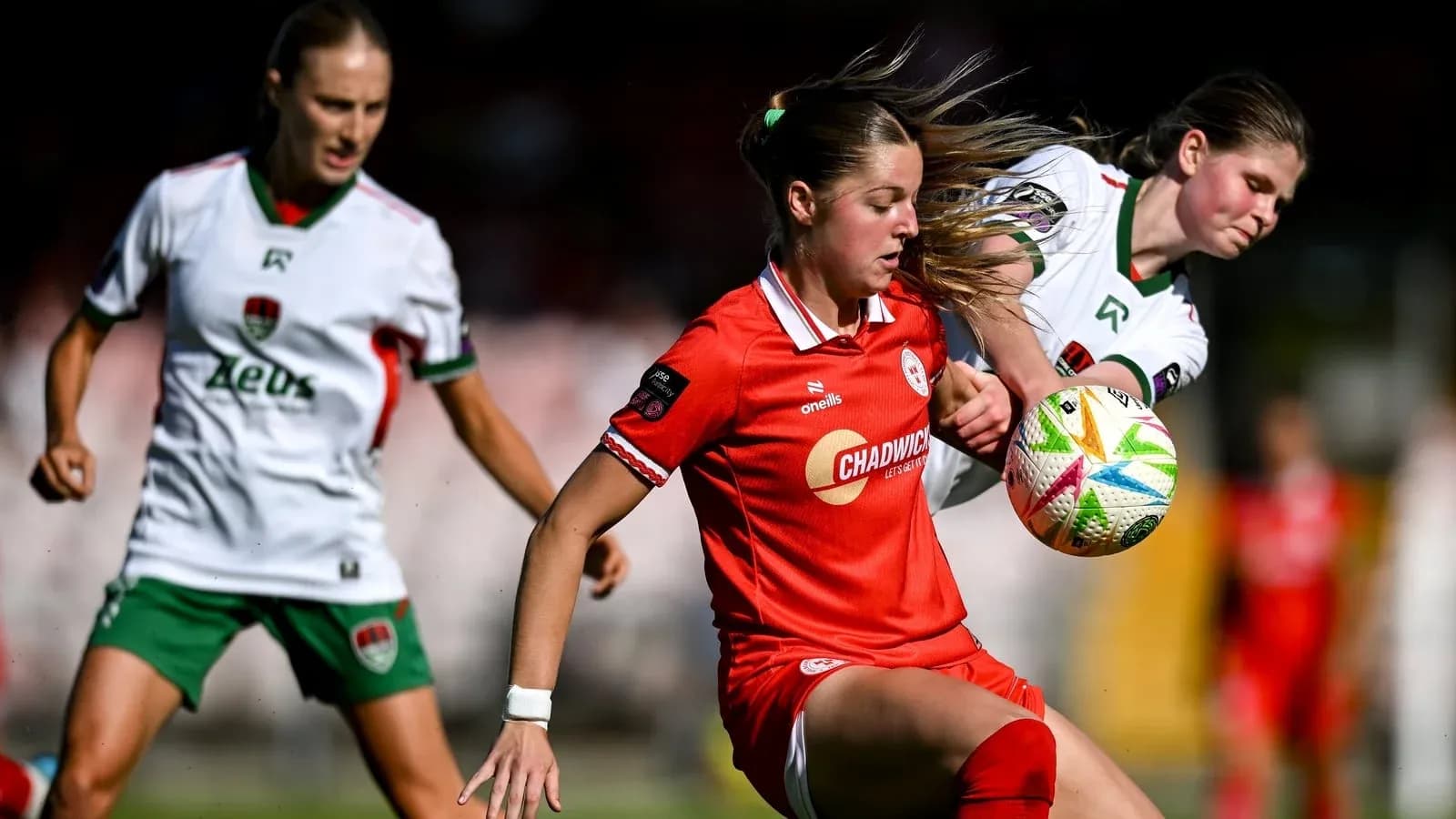 Two players contesting the ball during a match Two players contesting the ball during a match