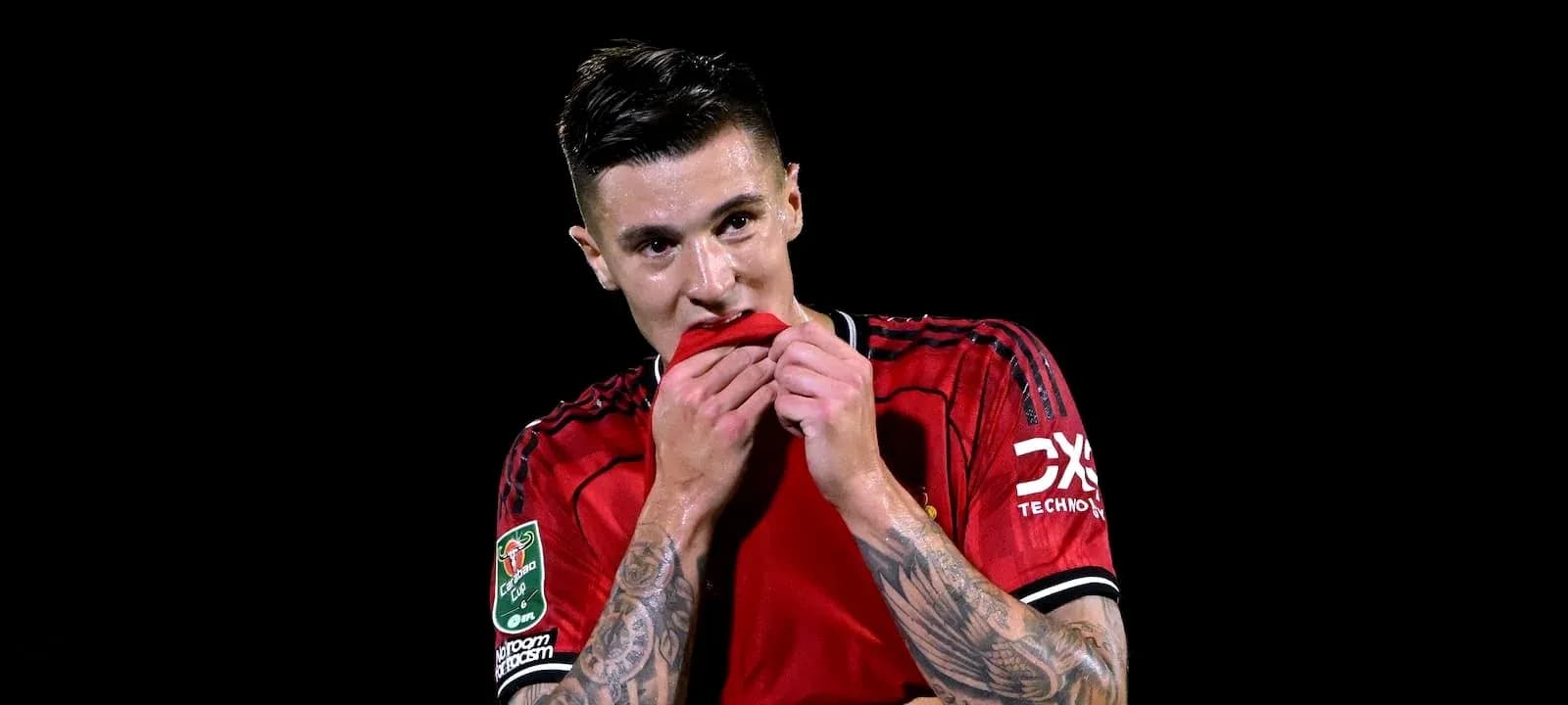 Player biting jersey after match on dark background Player biting jersey after match on dark background