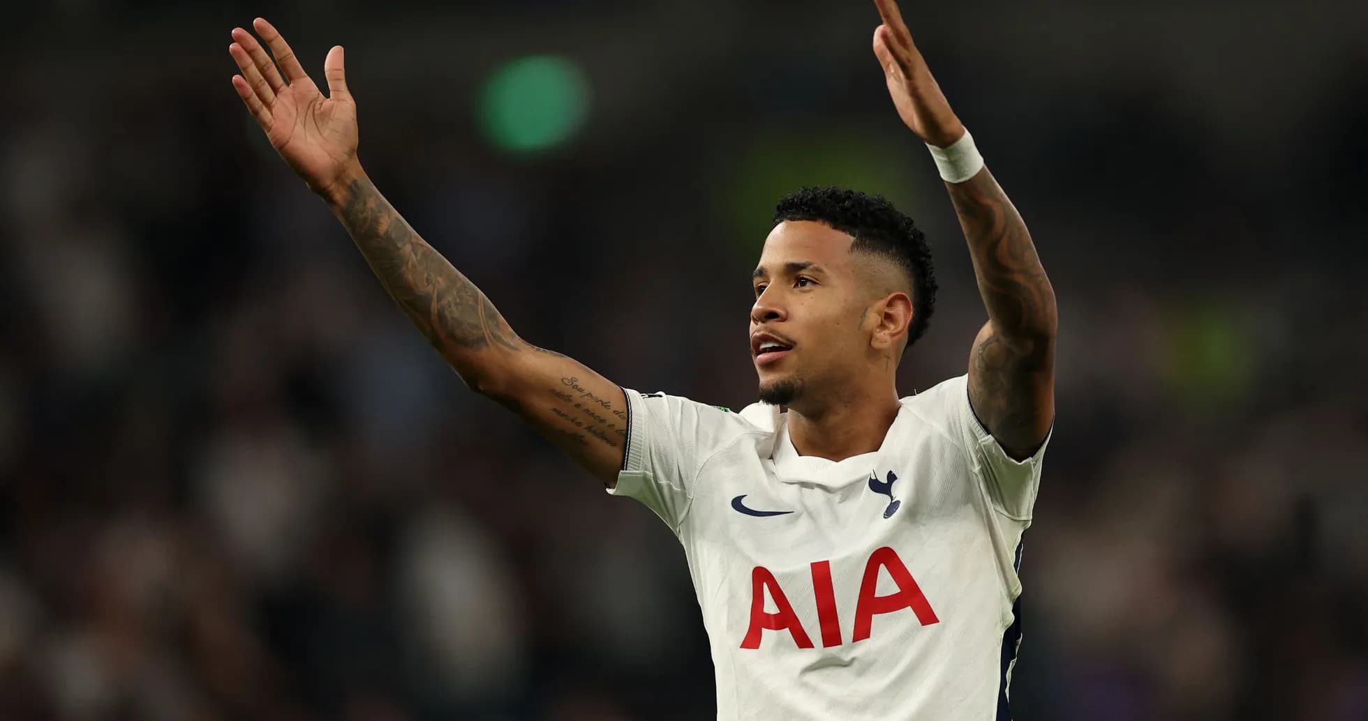 Player celebrating with raised arms on the field Player celebrating with raised arms on the field