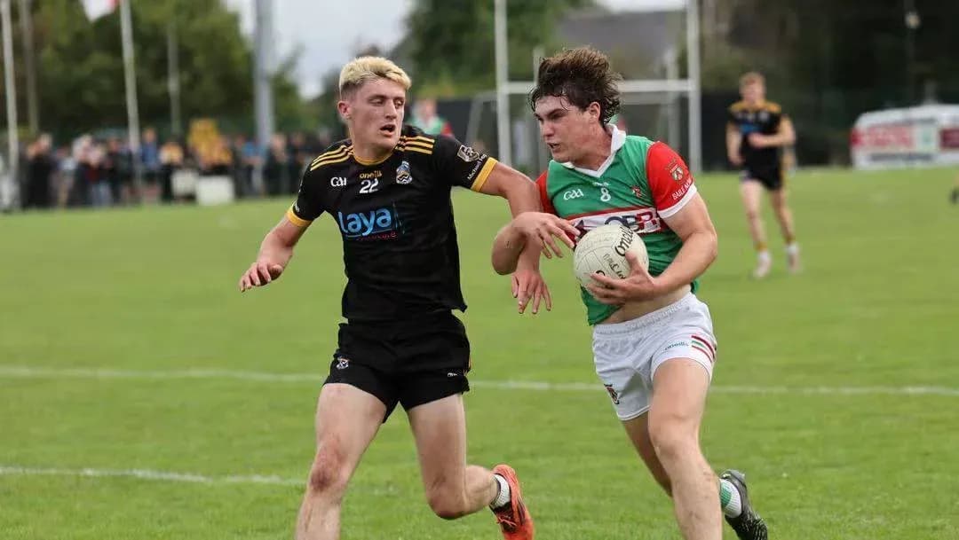 Two players competing for possession of a ball Two players competing for possession of a ball
