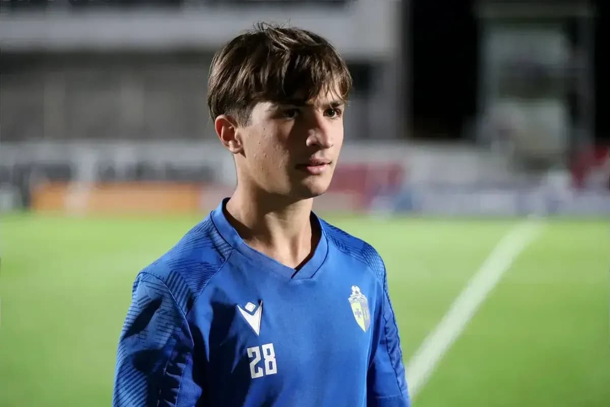 Young player in blue jersey standing on field Young player in blue jersey standing on field
