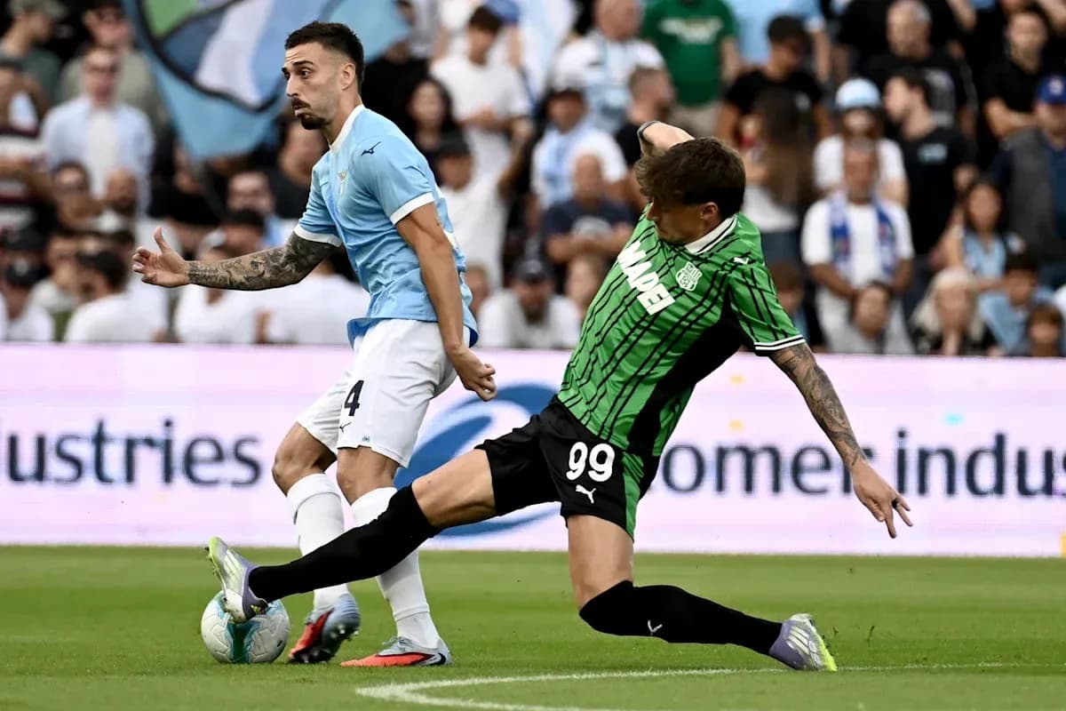 Player from Lazio evading tackle during match Player from Lazio evading tackle during match