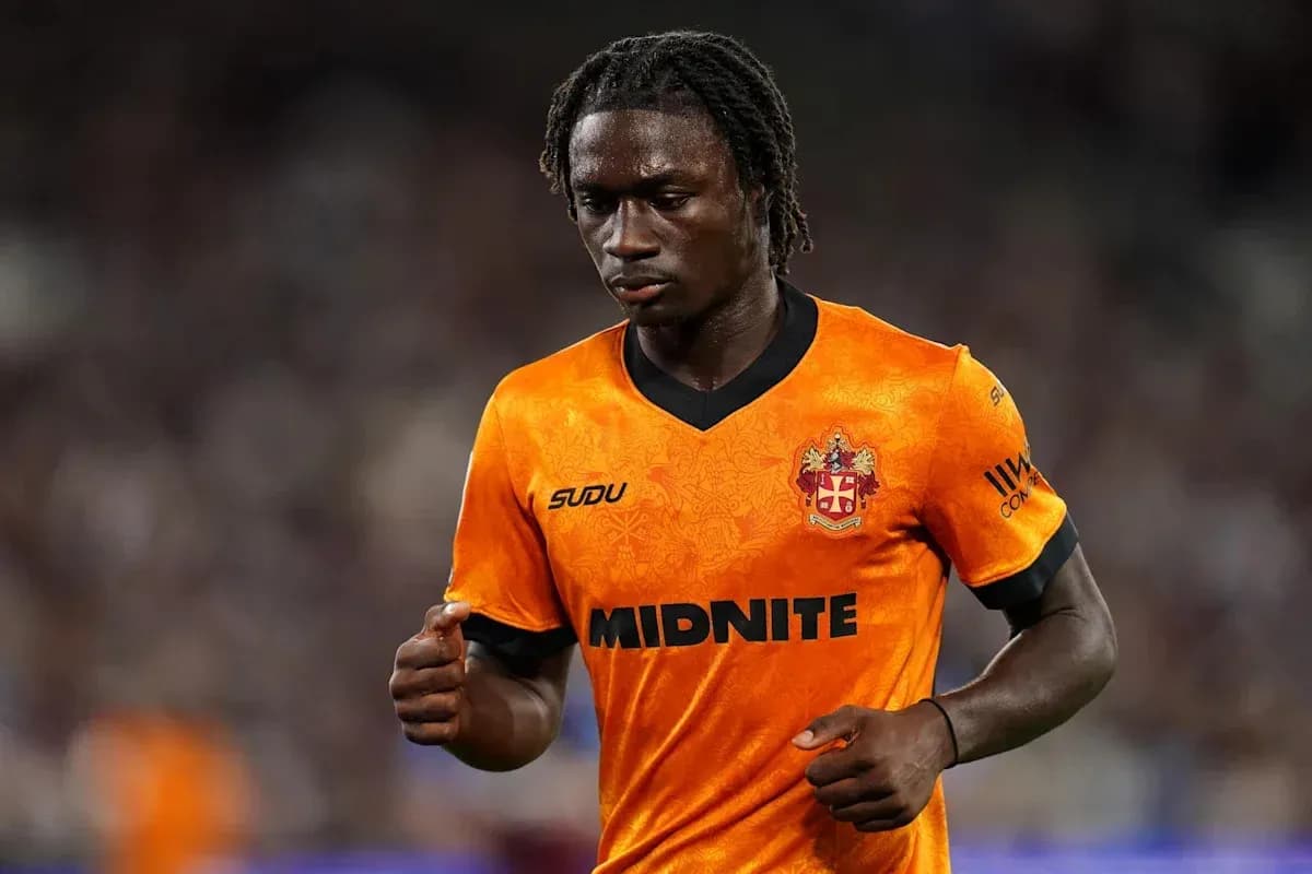 Player in orange jersey walking on the field Player in orange jersey walking on the field