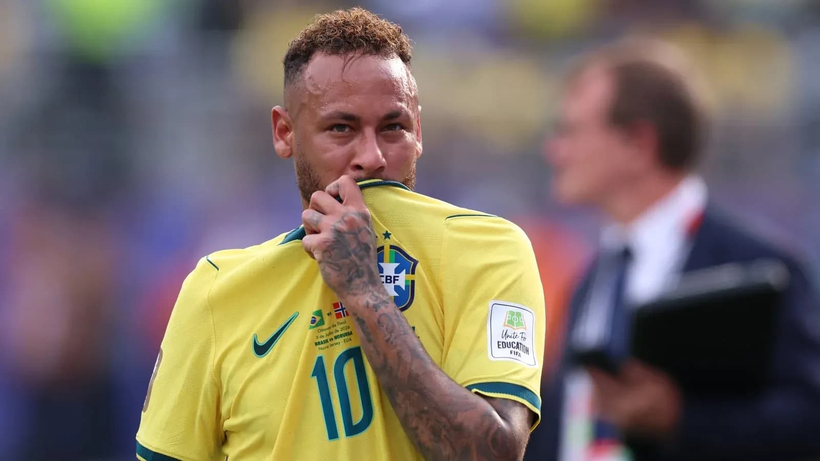 Player in Brazil jersey touching his shirt Player in Brazil jersey touching his shirt