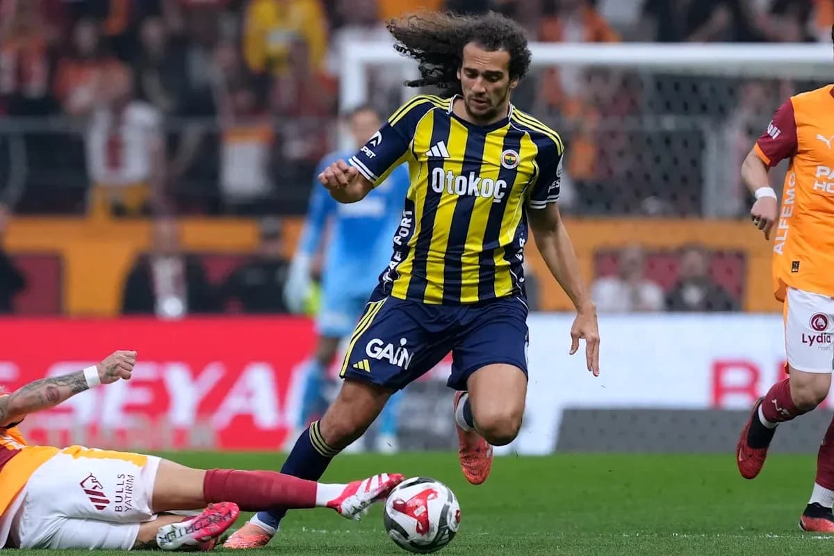Player in yellow and blue jersey dribbling past opponent Player in yellow and blue jersey dribbling past opponent